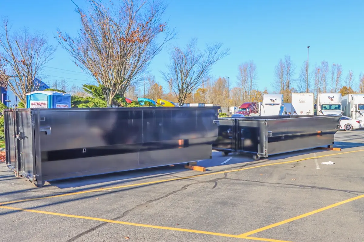 Professional dumpster rental service with roll-off container on residential driveway in Southaven